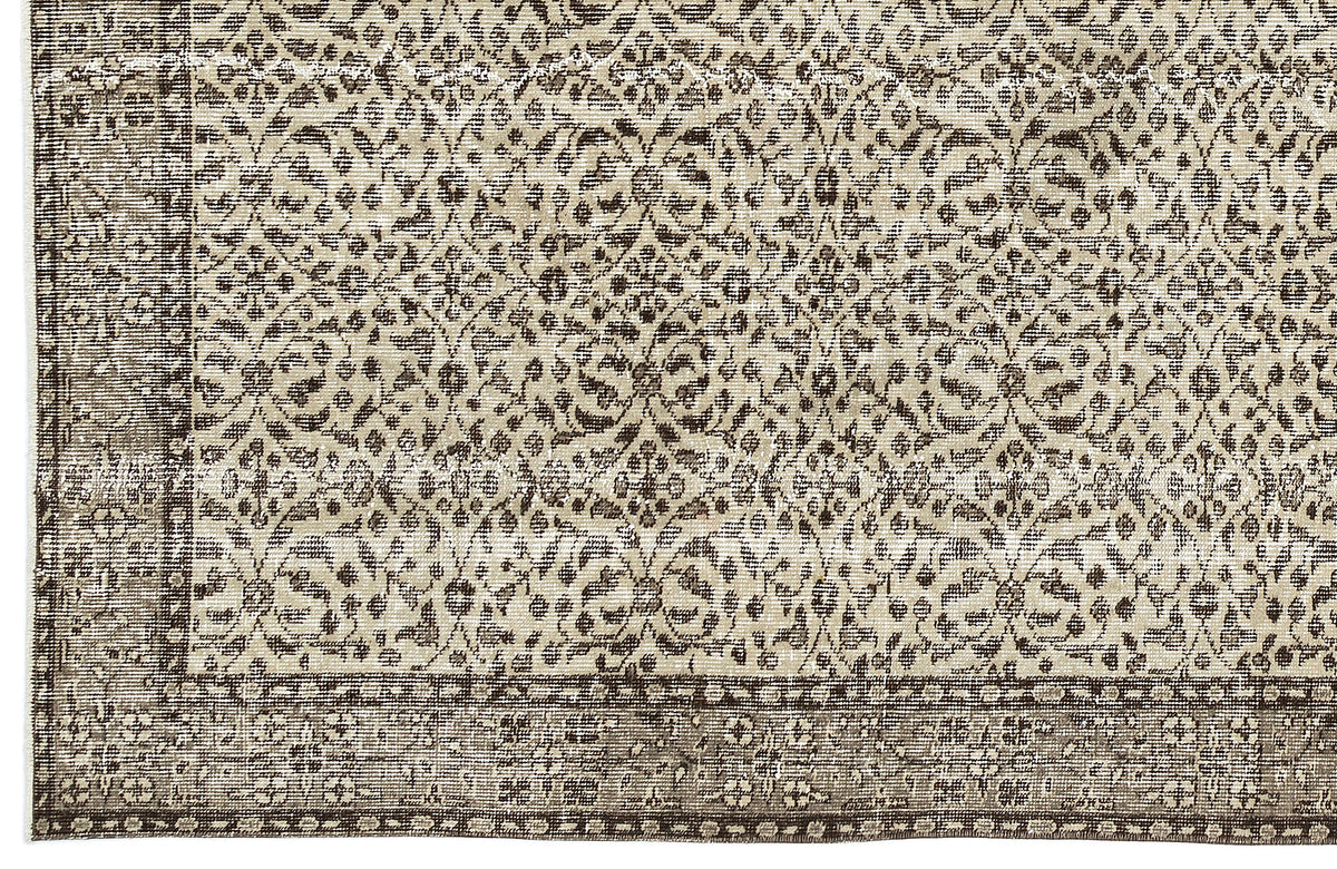 Beige and dark brown rug with a distressed, traditional floral medallion pattern and a wide decorative border.