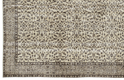 Load image 1 in gallery view. Beige and dark brown rug with a distressed, traditional floral medallion pattern and a wide decorative border.
