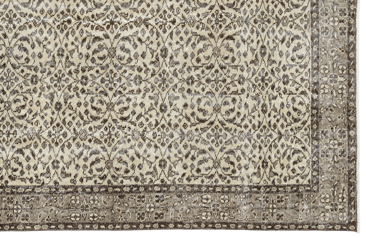 Beige and dark brown rug with a distressed traditional floral medallion pattern and a wide decorative border.