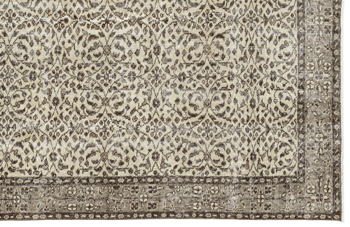 Load image 1 in gallery view. Beige and dark brown rug with a distressed traditional floral medallion pattern and a wide decorative border.