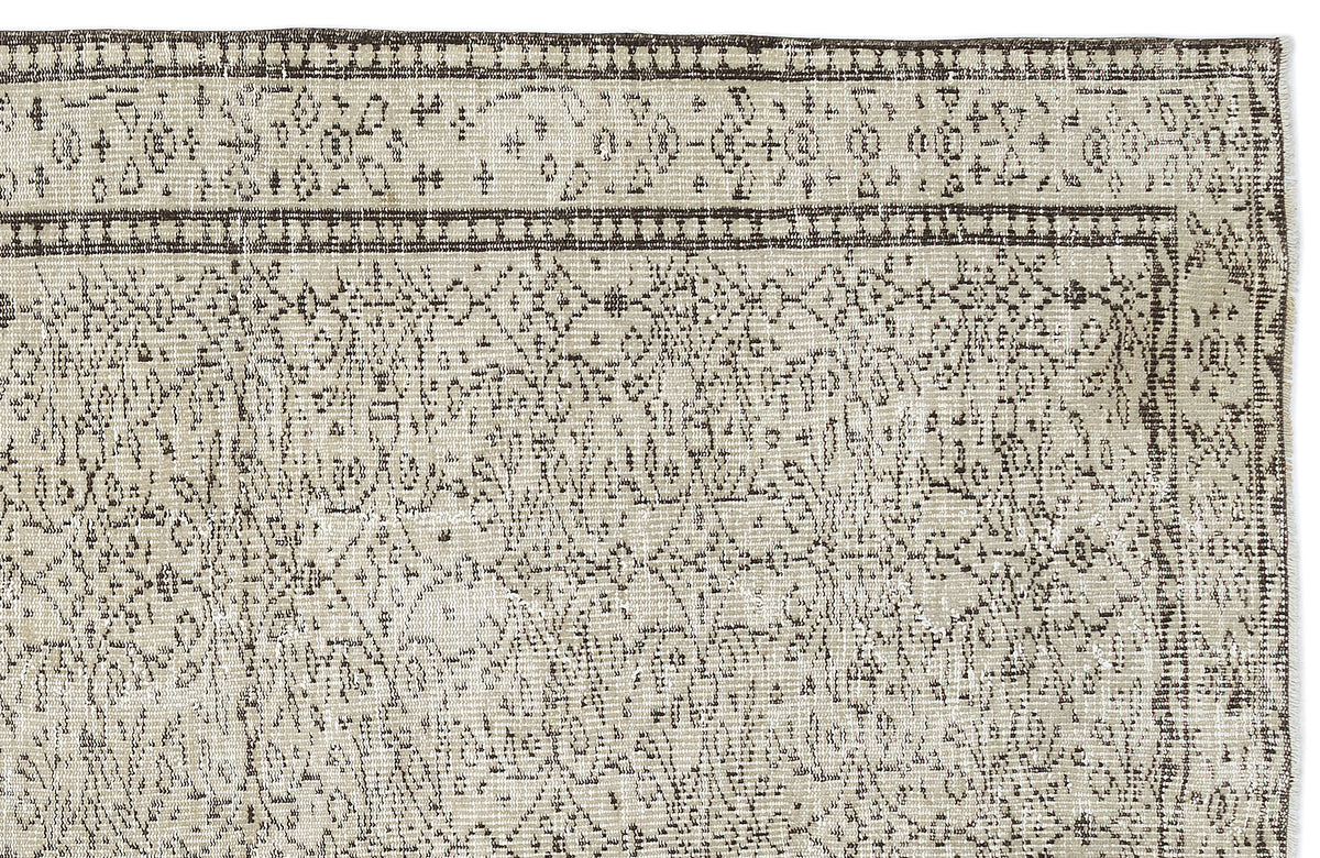 Beige and dark brown rug with a distressed traditional medallion pattern and a geometric border.
