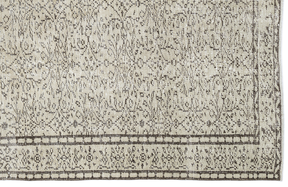 Beige and dark brown rug with a distressed traditional medallion pattern and a detailed geometric border.