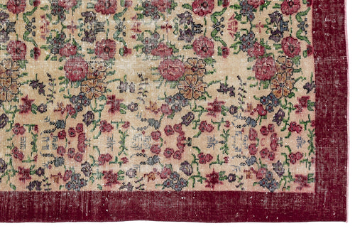 Load image 1 in gallery view. Beige vintage-style rug with a distressed floral pattern in red, green, and blue, featuring a solid dark red border.