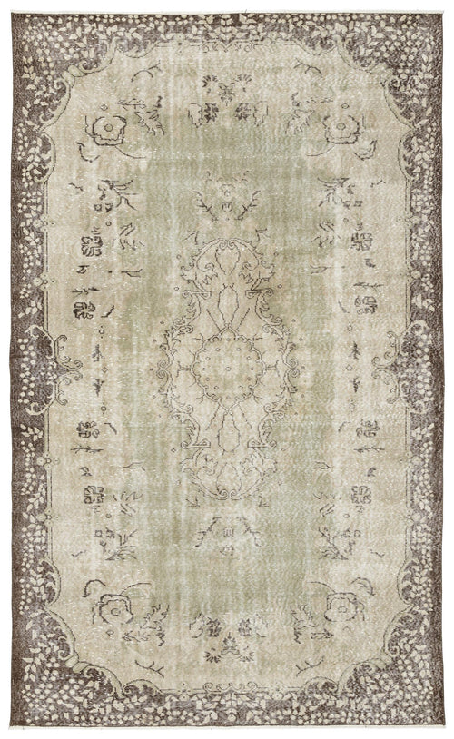 Load image 1 in gallery view. Sage green and brown distressed vintage-style rug with a central floral medallion and ornate border.