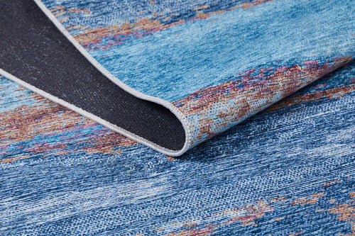 Load image 1 in gallery view. A close-up of the Abstract Elegance - Machine-Washable Rug JR87 (Custom Size) in blue shows its multicolored textures, a flipped corner revealing the black underside, and detailed edge stitching—ideal for high-traffic spaces.