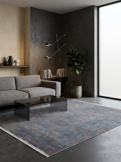 Bild 1 in Galerieansicht laden. Blue and copper distressed abstract rug in a modern living room with a grey sofa.