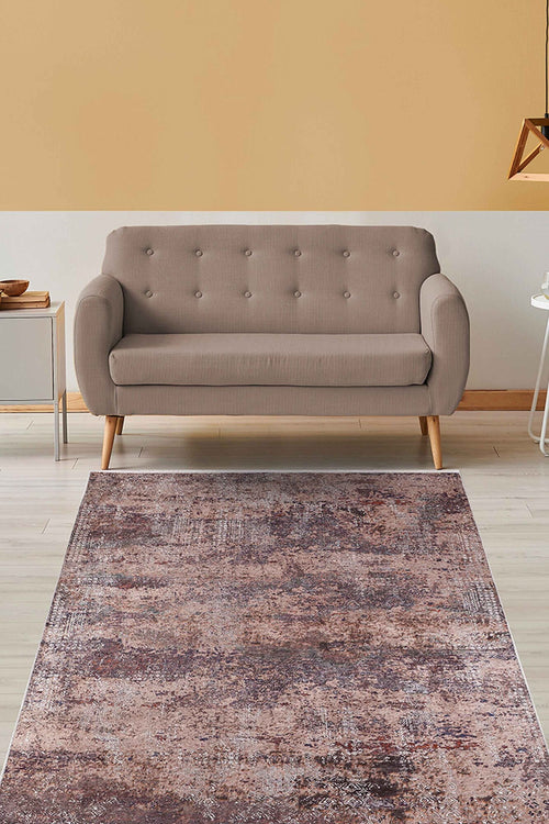 Load image 1 in gallery view. A modern living room with a beige tufted sofa, side table, geometric pendant light, and the Abstract Spectrum - Washable Rug - JR1427 (Custom Size) featuring a distressed brown and pinkish pattern—ideal for high-traffic spaces with light wood floors.