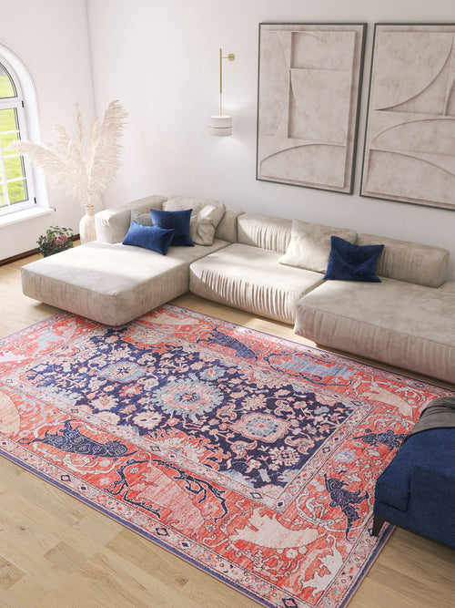 Bild 1 in Galerieansicht laden. A bright living room features a large cream sectional, blue and cream throw pillows, abstract wall art, sunlit window, and the Aegis Handmade-Design Washable Rug - LCC3029, adding vibrant color atop the light wood floor—ideal for high-traffic areas.