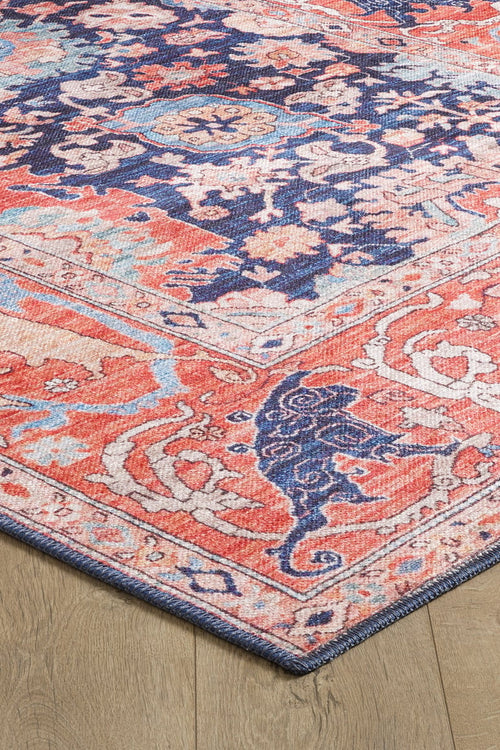 Bild 1 in Galerieansicht laden. A close-up of the Aegis Handmade-Design Washable Rug - LCC3029 shows its intricate coral, blue, cream, and navy floral and animal patterns on a wooden floor—ideal for high-traffic areas.