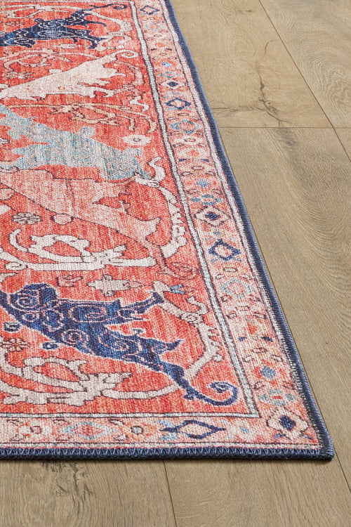 Bild 1 in Galerieansicht laden. A close-up of the Aegis Handmade-Design Washable Rug - LCC3029, featuring pink and blue patterns with a detailed border on a light wood floor. Its vibrant colors and flat weave make it ideal for high-traffic areas.
