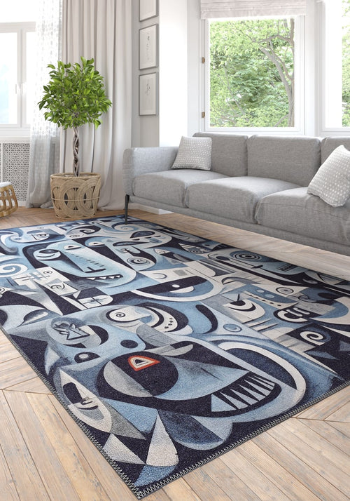 Load image 1 in gallery view. A modern living room features the Aesthetic Anomaly Contemporary Washable Rug - MDJ004 (Custom Size), with geometric and face-like patterns, under a light gray sofa, white pillows, potted plant, and large windows with white curtains.
