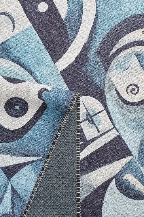 Load image 1 in gallery view. A close-up of the Aesthetic Anomaly Contemporary Washable Rug - MDJ004 (Custom Size) shows its blue, black, and white abstract face design. One corner is folded to reveal the stitched edge and reverse pattern—great for high-traffic areas.