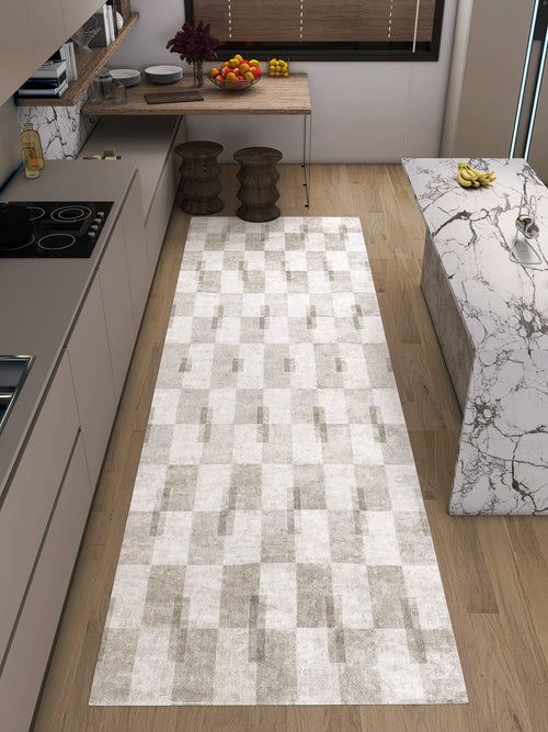 Load image 1 in gallery view. Modern kitchen with light wood flooring, minimalist beige cabinets, a custom-size Aged Elegance - Washable Rug - JRN37 in chevron pattern, marble countertop island, built-in stove, and bowls of fruit on counters and table.