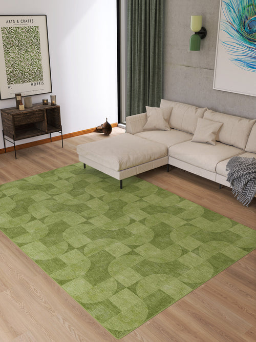 Load image 1 in gallery view. A modern living room features a light beige sectional sofa, wooden floor, and the Aged Serenity - Washable Rug - JRN51 with geometric patterns. Wall art, a console table with decor, and green curtains by a large window complete this stylish space.
