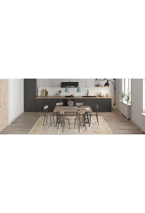 Load image 1 in gallery view. A modern dining room with a round wooden table, seven chairs, and the Aged Splendor - Washable Rug - JR1906—perfect for busy spaces. The kitchen has dark lower cabinets, white uppers, and two blue pendant lights in the background.