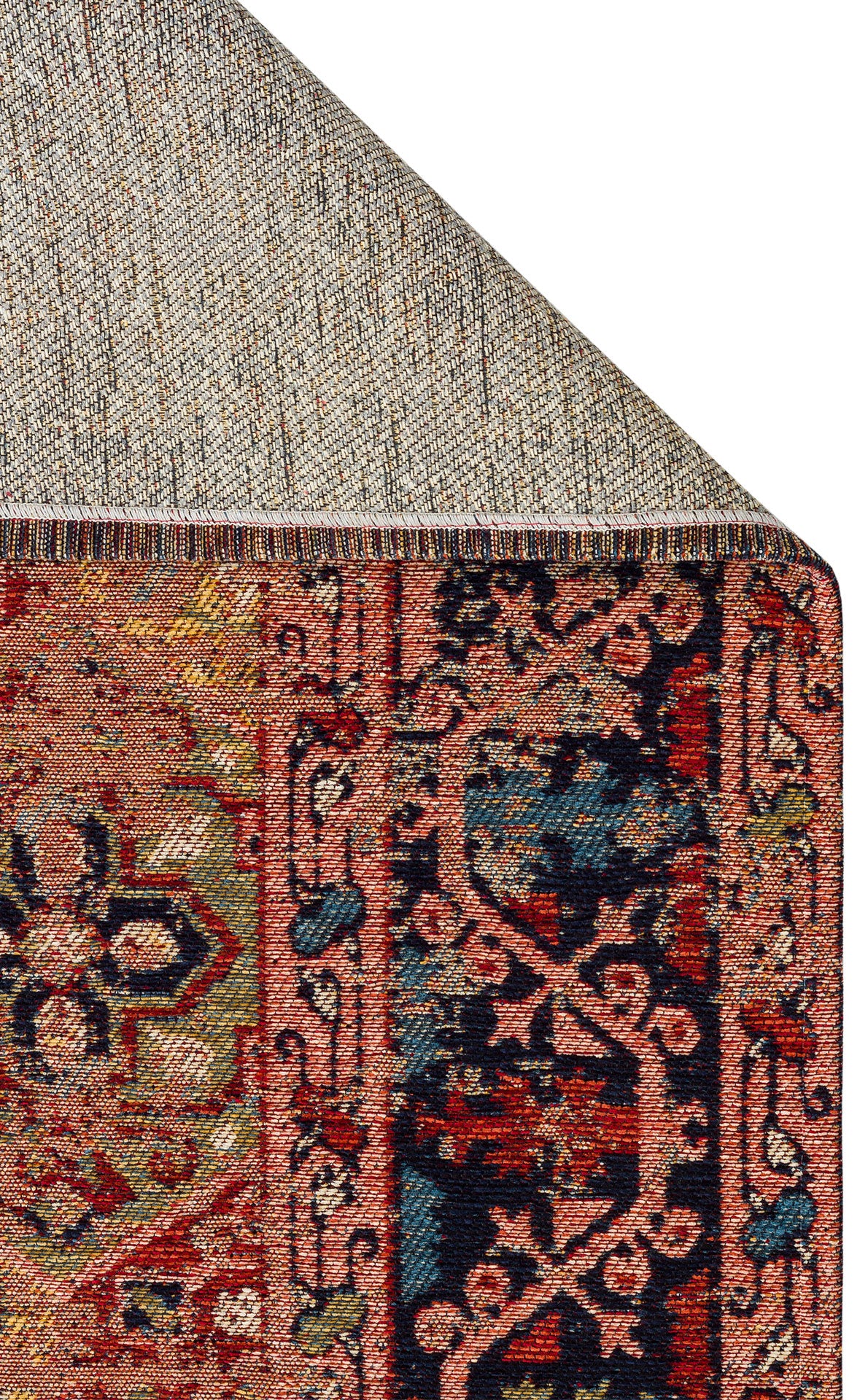 The Anatolian Weave - Washable Kilims - AND01 features a colorful, ornate flatwoven design with intricate floral and geometric traditional motifs in red, navy blue, green, and tan. One corner is flipped to reveal the textured woven underside.