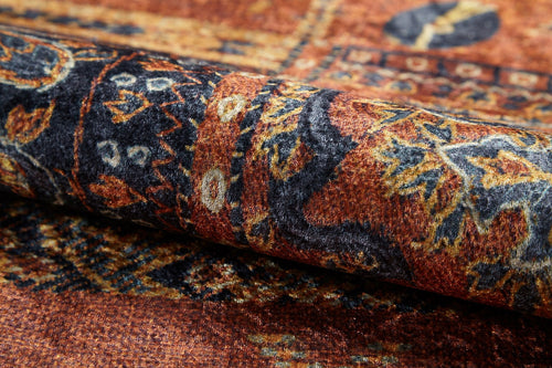 Load image 1 in gallery view. Close-up of the Ancient Palace - Washable Rug - JR1864 (Custom Size), featuring a rolled, patterned orange design with rich brown and dark blue accents, intricate traditional motifs, and a soft, velvety texture—ideal for high-traffic areas.
