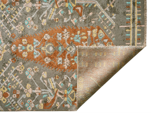 Load image 1 in gallery view. Olive green rug with a rust orange floral medallion pattern, teal and yellow accents, and a folded corner.