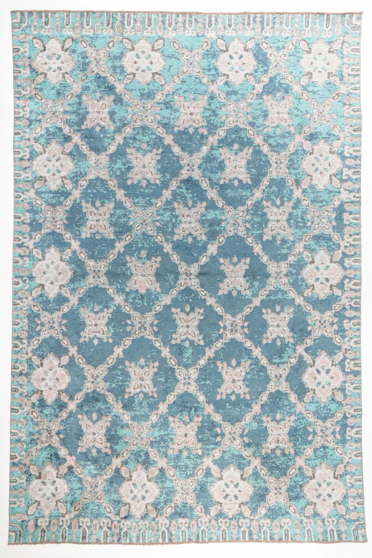 Ocean Trellis area rug with deep teal blue field and ivory lattice pattern with distressed floral motifs