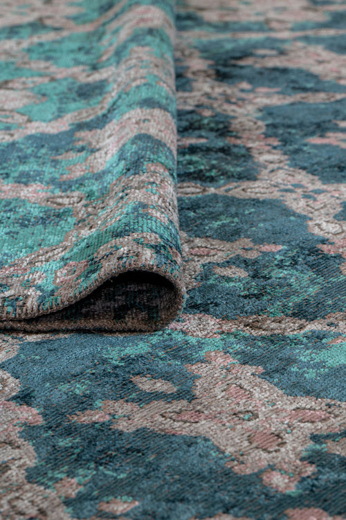 Load image 1 in gallery view. A close-up of the Ocean Trellis Area Rug APX1942 shows its teal, blue, and beige tones. The edge is slightly lifted, highlighting the modern flatwoven texture and intricate pattern.