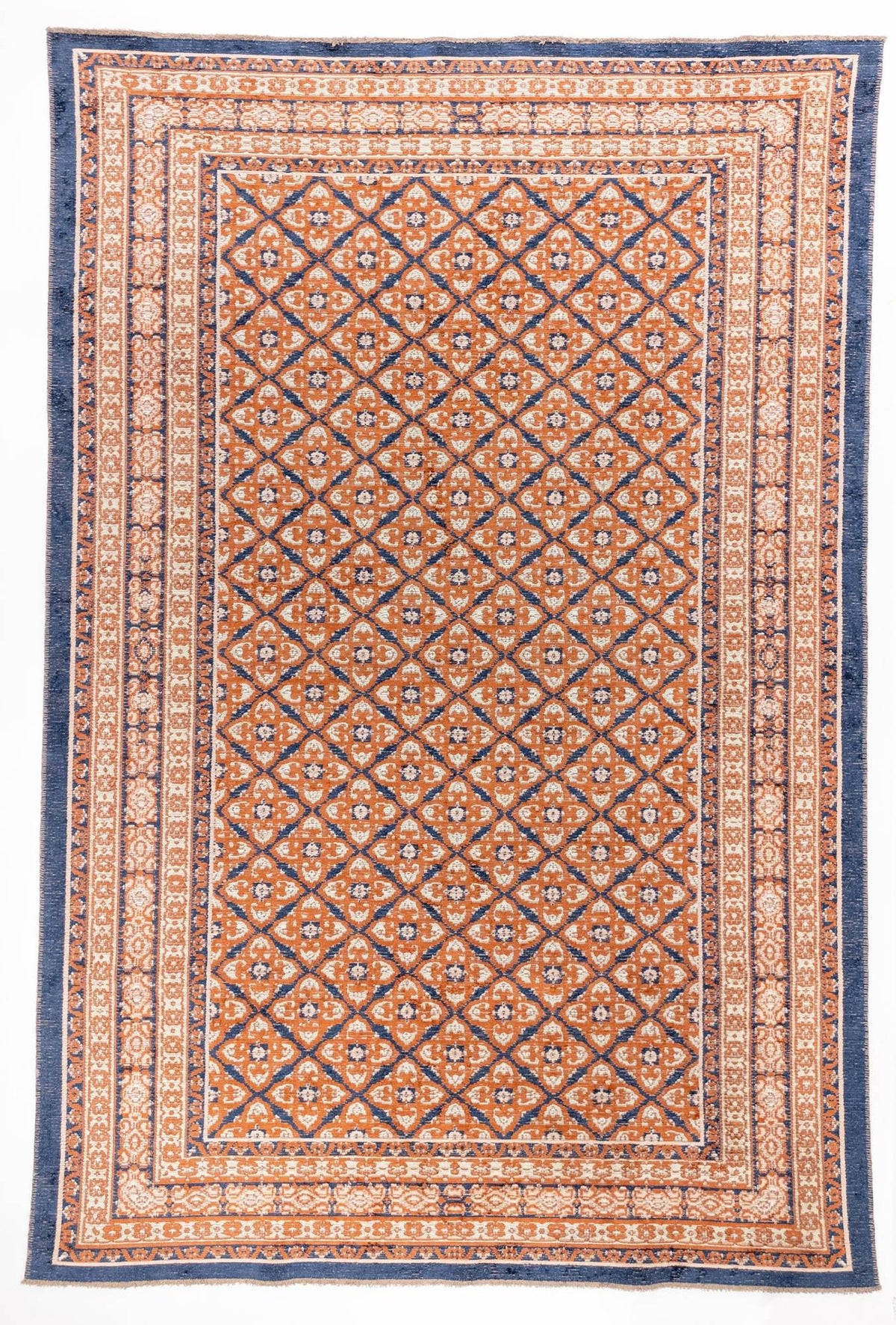 Spice Lattice area rug with rust orange field, cream diamond lattice pattern, and navy blue triple border