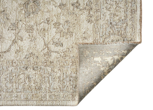 Load image 1 in gallery view. A close-up of the Stone Garden Area Rug APX1961 shows its beige and light brown distressed Persian pattern, with one corner flipped to reveal the underside and texture for a vintage look.
