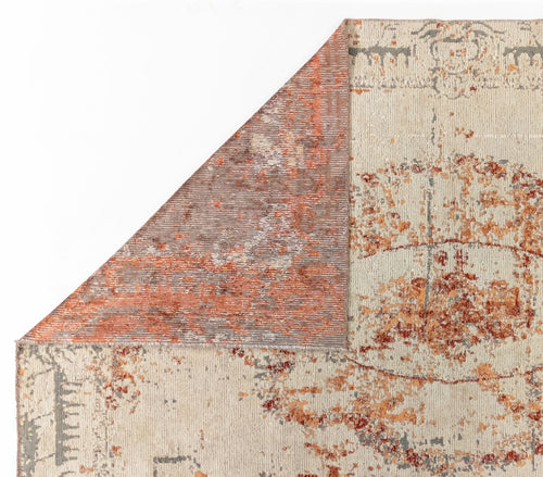 Load image 1 in gallery view. Cream, rust, and grey distressed medallion rug with a corner folded over to reveal the textured backing.