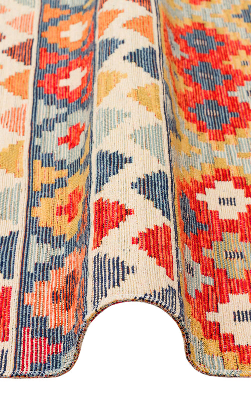Bild 1 in Galerieansicht laden. The Aqua Flow - Washable Reversible Kilim - NMD02 is a Southwestern statement rug with bold geometric diamonds and florals in red, blue, yellow, and cream, plus a curved edge for added style.