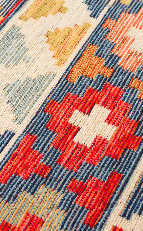 Bild 1 in Galerieansicht laden. Close-up of the Aqua Flow - Washable Reversible Kilim (NMD02), featuring a vibrant folk-inspired Southwestern pattern with red, blue, yellow, and white geometric shapes and stripes.