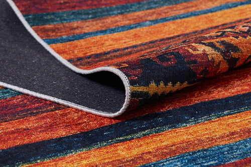 Load image 1 in gallery view. A close-up of the Arctic Chill - Washable Rug - JR860 (Custom Size), featuring orange, red, blue, and yellow stripes with a lifted corner revealing its dark textured underside—ideal for high-traffic areas.