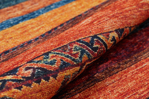 Load image 1 in gallery view. A close-up of the Arctic Chill - Washable Rug - JR860 (Custom Size) shows its multicolor horizontal red, orange, and blue stripes with dark blue and yellow patterns—perfect for high-traffic areas and easy to wash.