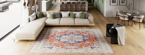 Load image 1 in gallery view. Modern living room featuring a large cream sectional sofa, green accent pillows, and an Ardentis Medallion Washable Rug - LCC3002. Dining area with barstools is visible in the background. Light wood floors throughout.