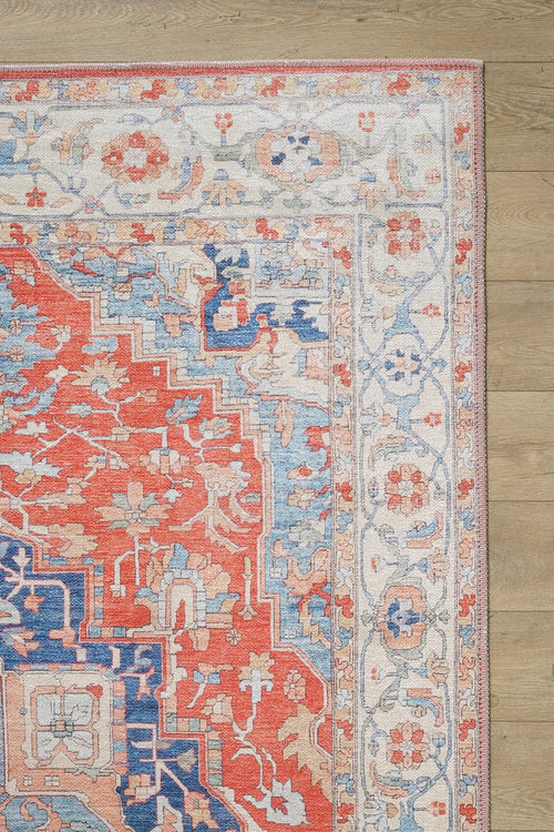 Load image 1 in gallery view. A close-up of the Ardentis Medallion Washable Rug - LCC3002 (Outlet) US, featuring colorful floral and geometric patterns in red, blue, beige, and white on a light wooden floor.