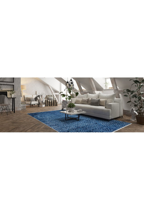 Load image 1 in gallery view. A modern loft living room with a white sofa, neutral pillows, a glass coffee table, green potted plants, and the Art Deco Elegance - Washable Rug - JR1224 (Custom Size). Slanted ceiling beams and large windows create an airy vibe.