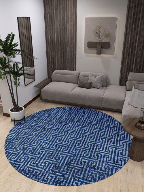 Load image 1 in gallery view. A modern living room with a gray sectional, light wood floors, wall art, a mirror, potted plant, a small round side table, and the Art Deco Elegance - Washable Rug - JR1224 (Custom Size), ideal for high-traffic areas.