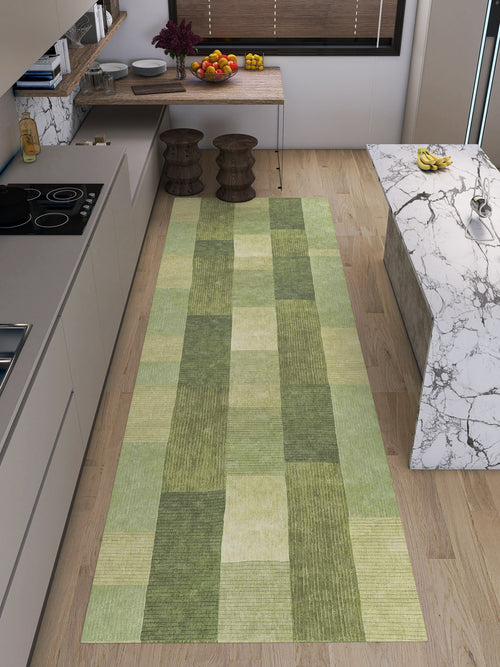 Bild 1 in Galerieansicht laden. A modern kitchen with light wood floors, a marble island, two wooden stools, and Artisanal Essence - Washable Rug - JRN32 runner—ideal for high-traffic spots—plus fruit bowls, plants, and kitchenware on the countertop.