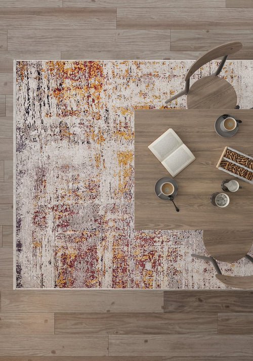 Load image 1 in gallery view. A top view shows a modern table set with coffee cups, an open book, and breadsticks, surrounded by wooden chairs on the Artistic Abstraction - Washable Rug - JR775 (Custom Size) with red, orange, yellow, and white tones.
