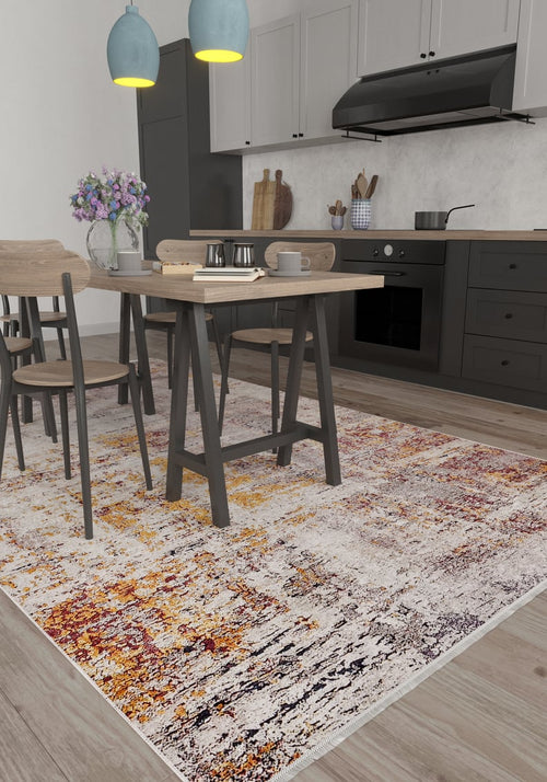 Load image 1 in gallery view. Modern kitchen and dining area with black cabinets, light wood furniture, a vase of purple flowers on the table, two blue pendant lights, and the Artistic Abstraction - Washable Rug - JR775 (Custom Size) in orange, yellow, and cream tones on the floor.