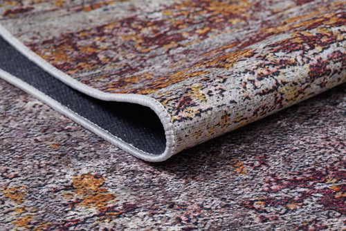 Load image 1 in gallery view. A close-up of the Artistic Abstraction - Washable Rug - JR775 (Custom Size) features a multicolored flat weave with a folded corner, displaying textured gray, yellow, and red patterns and a white stitched edge.