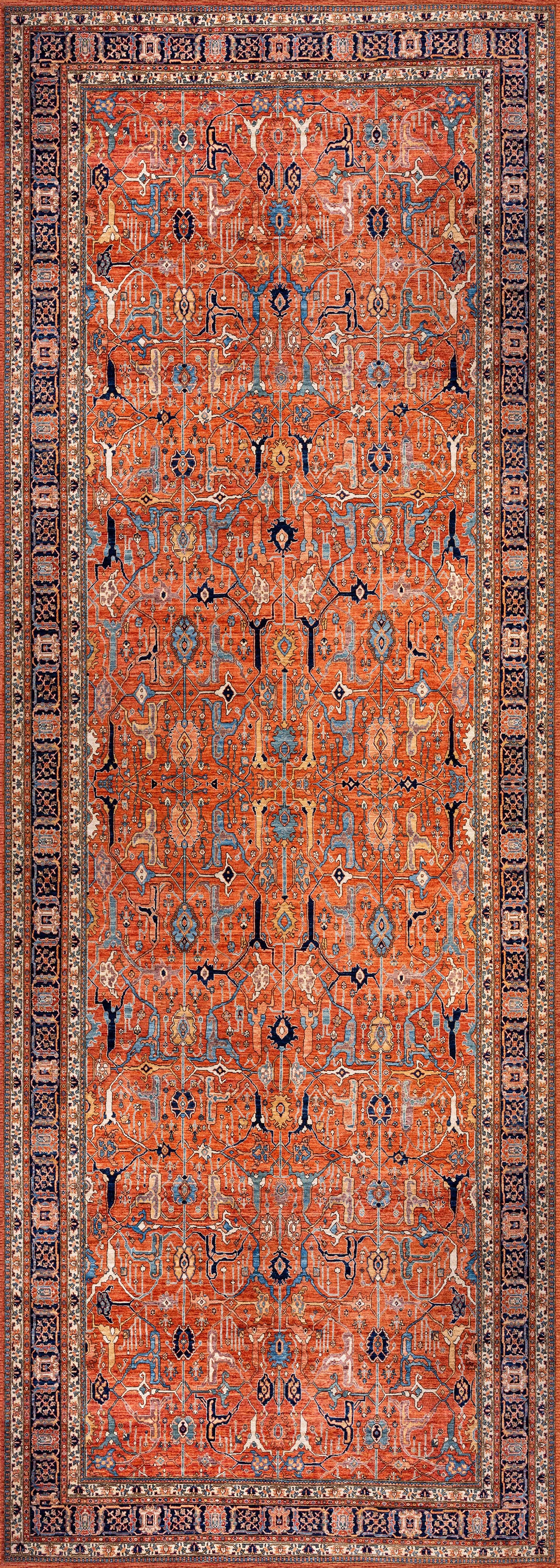 The Aurelius Coral Washable Rug - LCC3005 is a rectangular flat weave featuring an intricate geometric pattern in red, blue, and beige. Durable and ideal for high-traffic areas, it displays repeating motifs framed by decorative borders.
