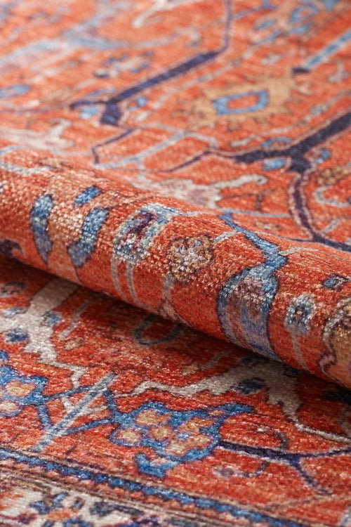 Load image 1 in gallery view. Close-up of the Aurelius Coral Washable Rug - LCC3005, showcasing its intricate flat weave pattern in red, blue, cream, and orange tones. The textured details are visible, making it ideal for high-traffic areas.