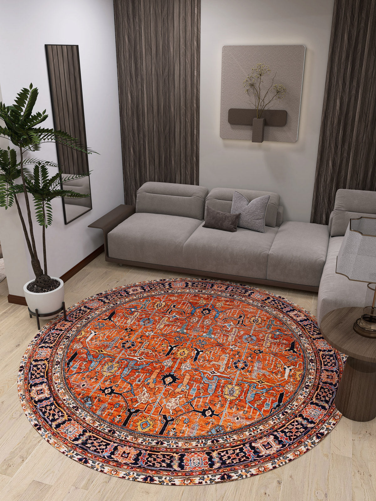 A modern living room showcases the Aurelius Coral Washable Rug - LCC3005 (Custom Size), a round, vibrant orange rug ideal for high-traffic areas, paired with a gray sectional sofa, potted plant, side table, wall art, and wooden panels.