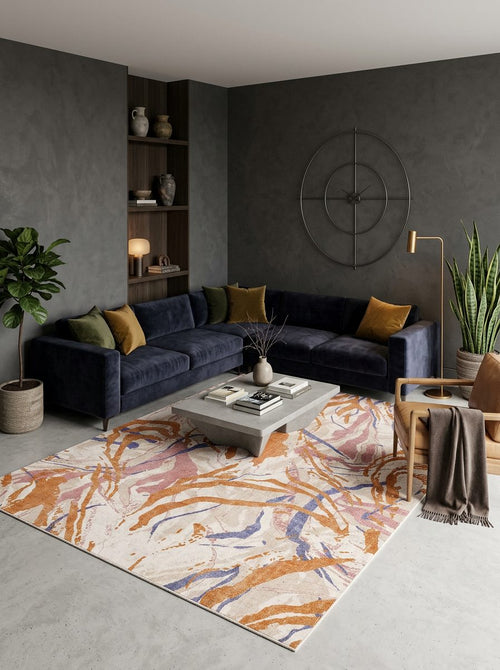 Load image 1 in gallery view. Cream rug with abstract orange, pink, and blue brushstroke patterns, styled in a modern living room.