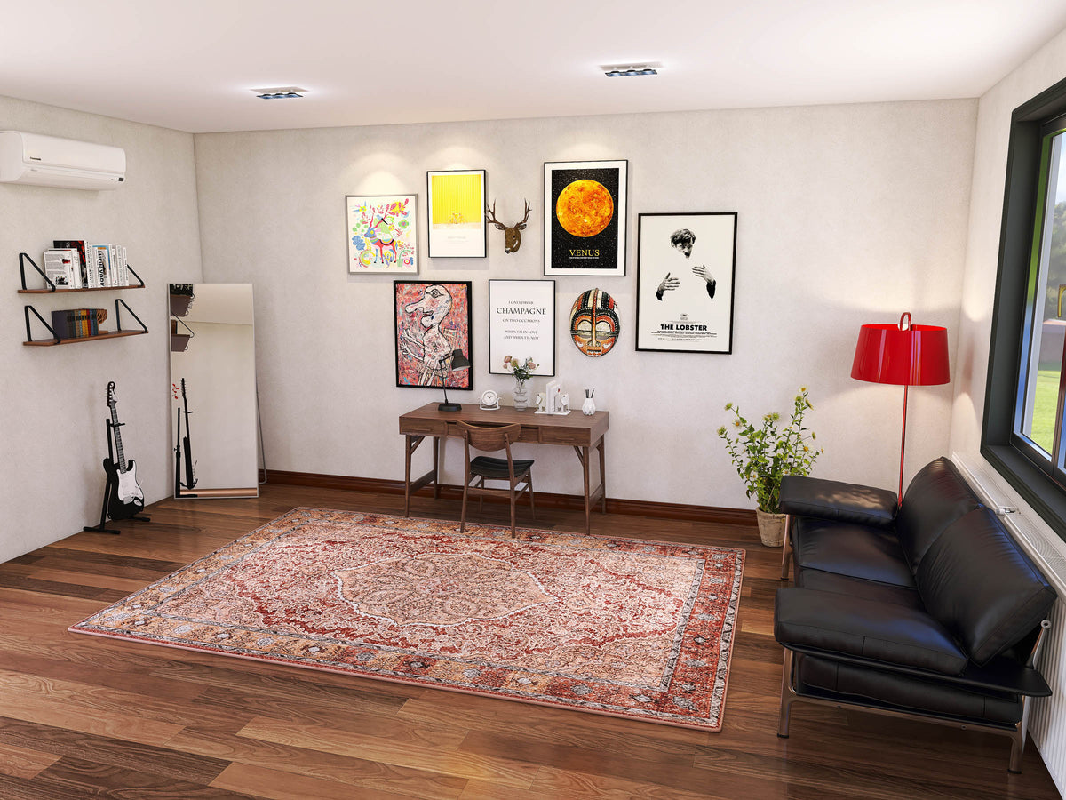 A stylish home office with a wall desk, black leather sofa, red lamp, framed art, guitar, plants, and floor mirror is brightened by natural light. The Baroque Charm - Washable Rug - JRN1016 adds vintage-inspired elegance to the space.