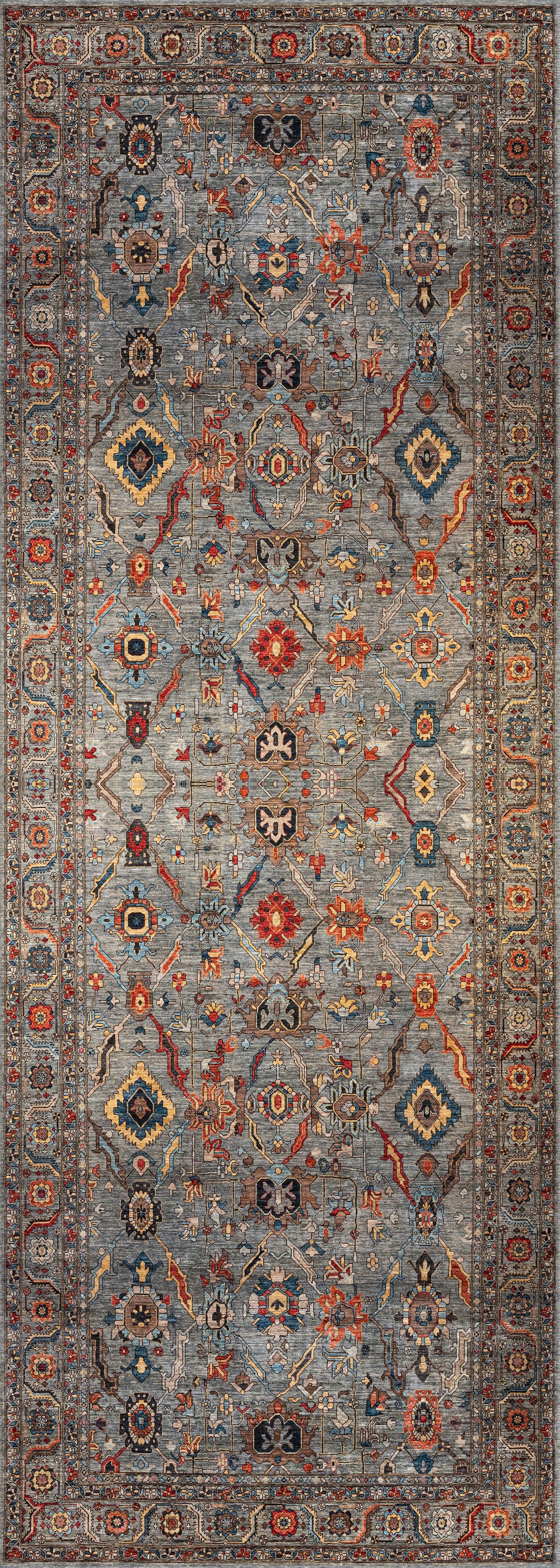 The Bellaris Gray Washable Rug - LCC3003 is a rectangular rug with an intricate geometric and floral pattern in blue, red, gold, and cream, detailed border, symmetrical design, and ideal for allergy-sensitive spaces.