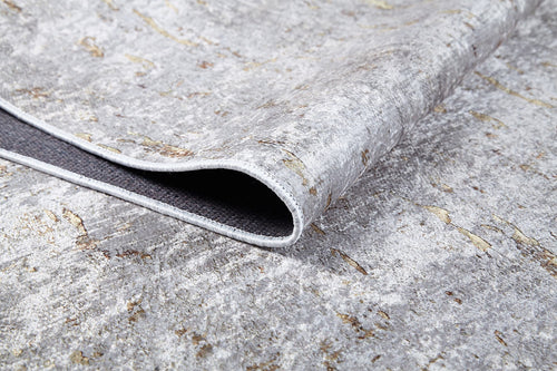Load image 1 in gallery view. Close-up of the Berry Blossom - Washable Rug - JR1818 (Custom Size) in textured gray-anthracite with a folded corner, showing its dark non-slip backing. This flat weave rug has a marbled, stone-like pattern for stylish spaces.