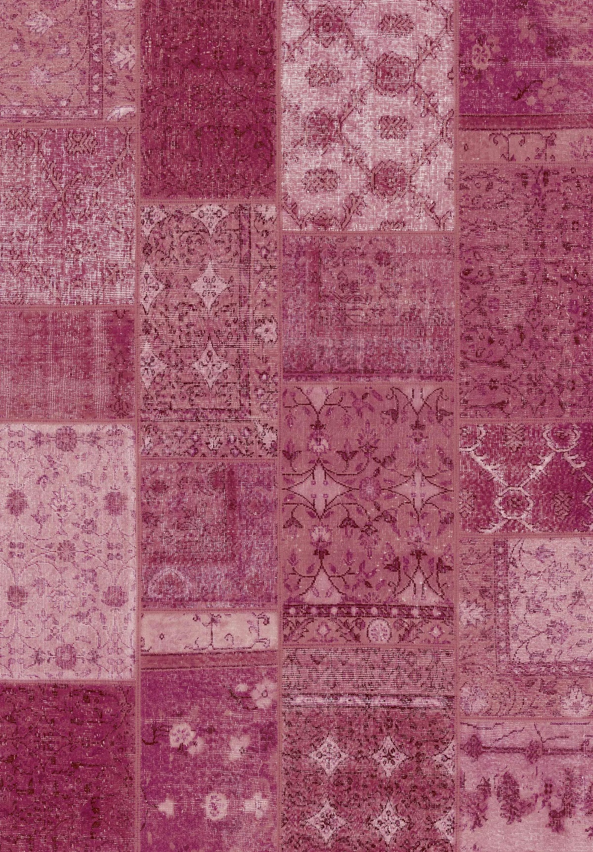 The Berry Patchwork - Washable Rug (JRN1040) showcases intricate vintage-style patterns in pink, magenta, and burgundy. Its rectangular patches feature unique floral and geometric designs—perfect for high-traffic areas.