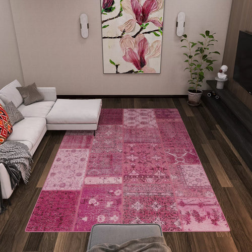Load image 1 in gallery view. Modern living room with a white sectional sofa, gray blanket, red pillow, potted plant, floral wall art, TV on a dark wood entertainment unit, and the Berry Patchwork - Washable Rug - JRN1040 perfect for high-traffic areas.