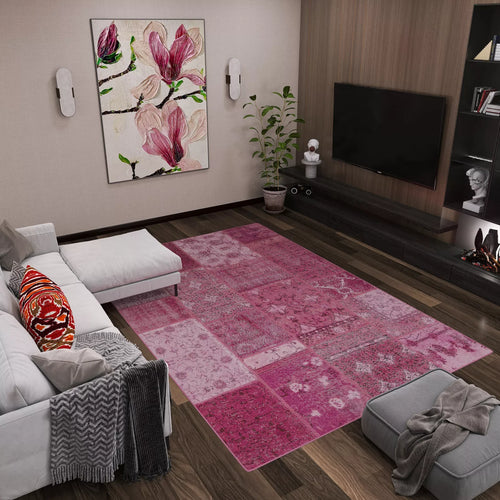 Load image 1 in gallery view. Modern living room with a white sofa, gray ottoman, the Berry Patchwork - Washable Rug (JRN1040)—perfect for high-traffic areas—large floral wall art, potted plant, flat-screen TV above a dark media unit with décor and small fireplace.