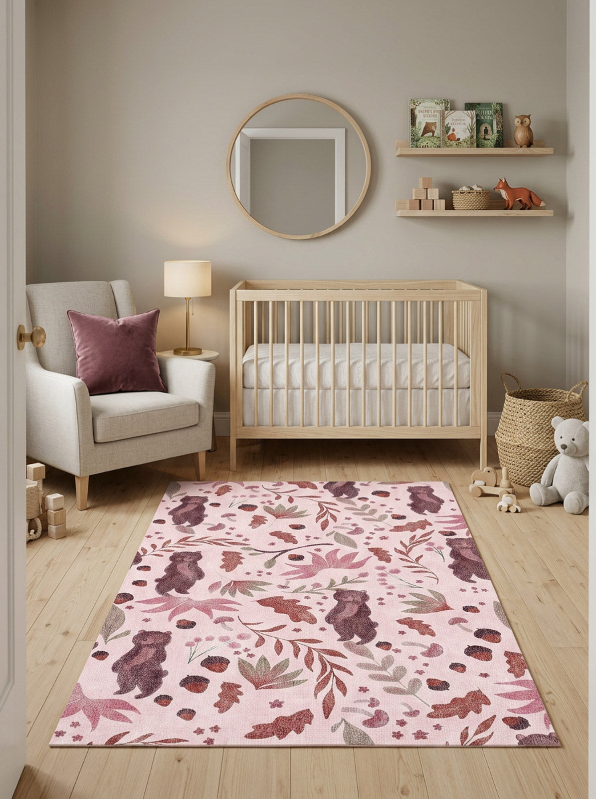Pink rug with a woodland pattern of bears, leaves, and acorns, styled in a nursery.
